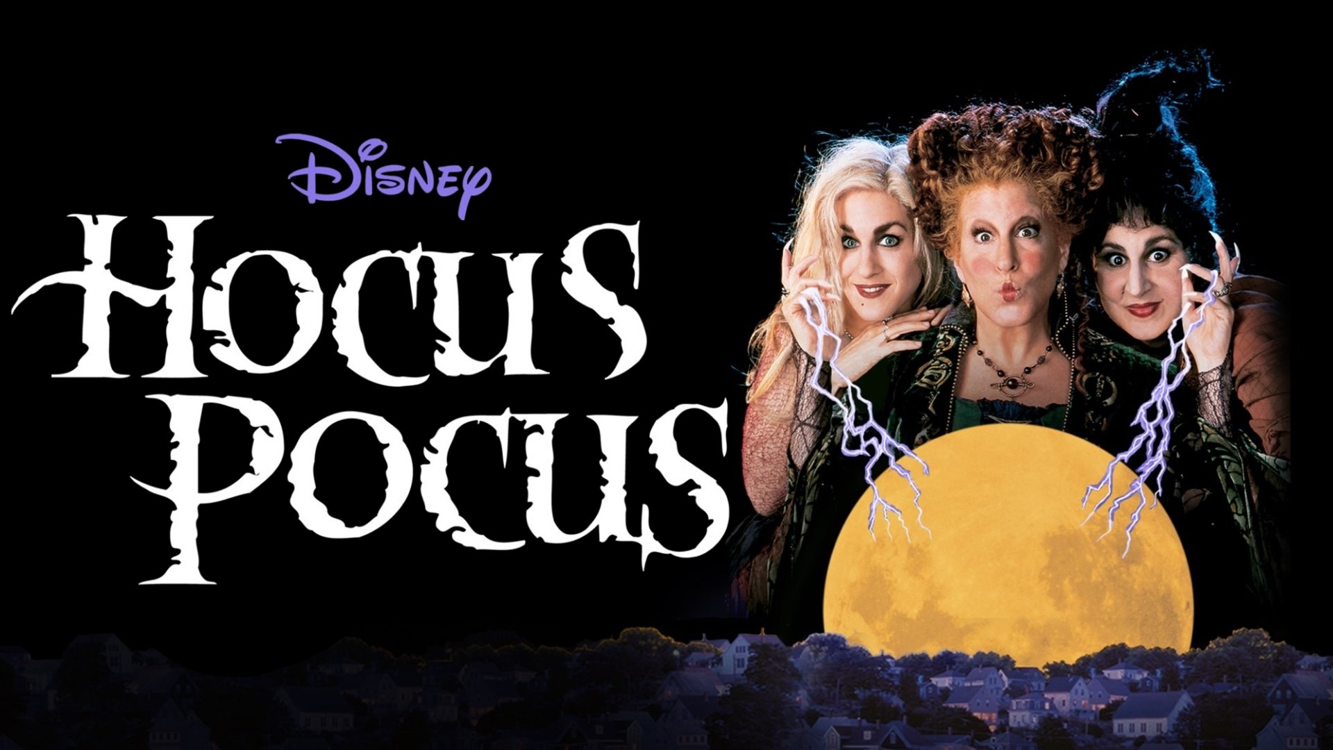 Three costumed witches with wild hair and lightning crackling from their fingertips, rising behind a glowing full moon over a darkened town