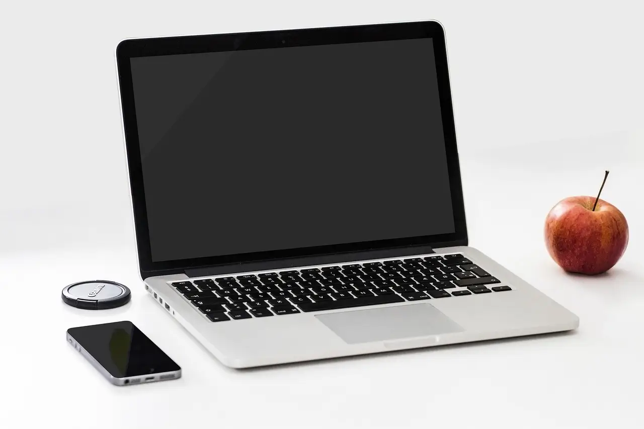 a laptop computer sitting on top of a white table