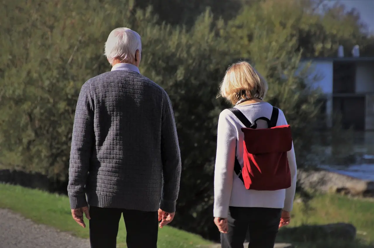 a man and a woman walking down a path