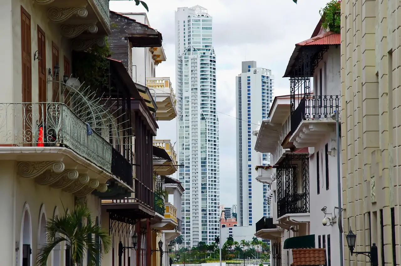 a city street with tall buildings in the background