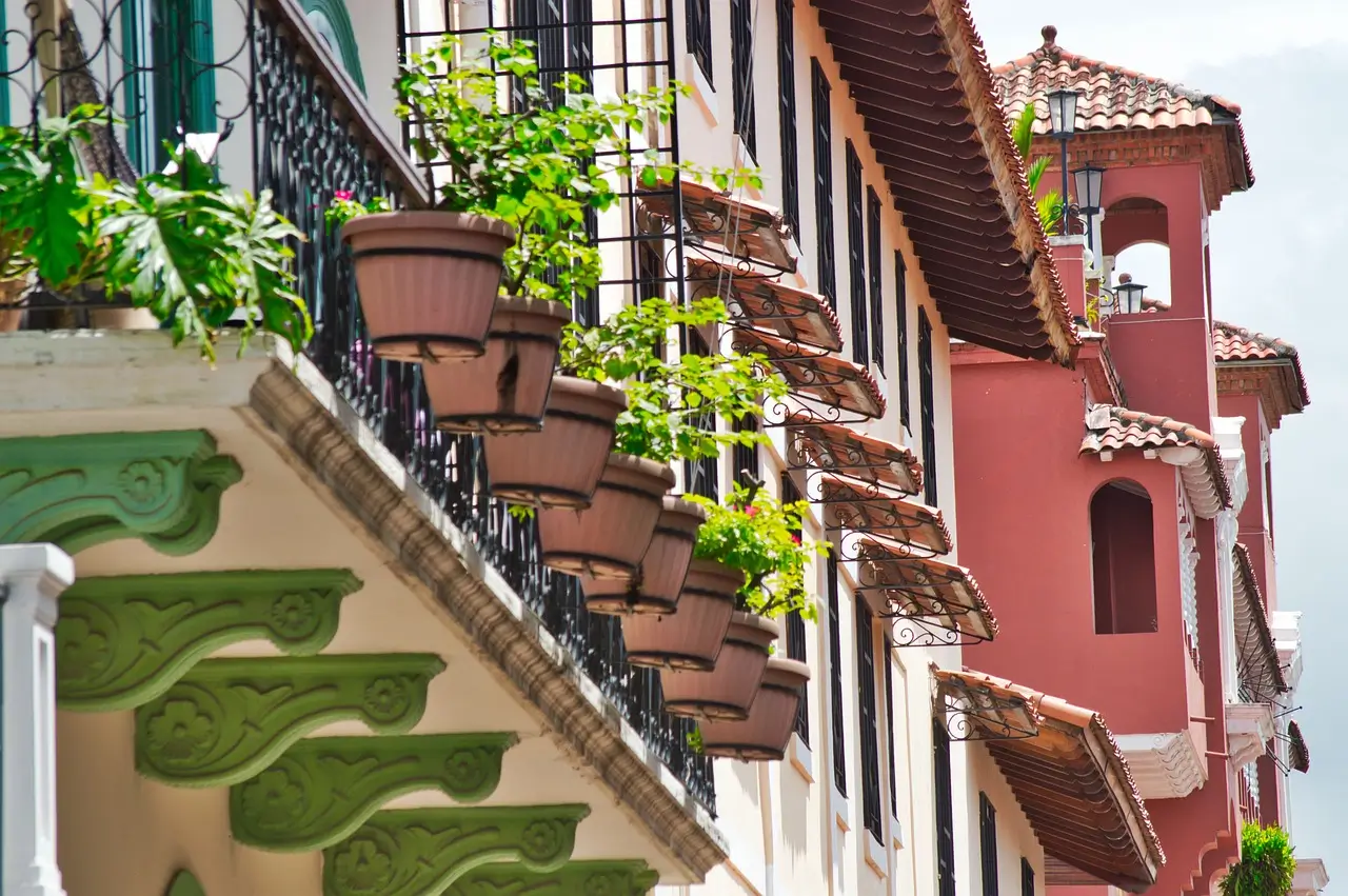 a row of buildings with planters on the balconies