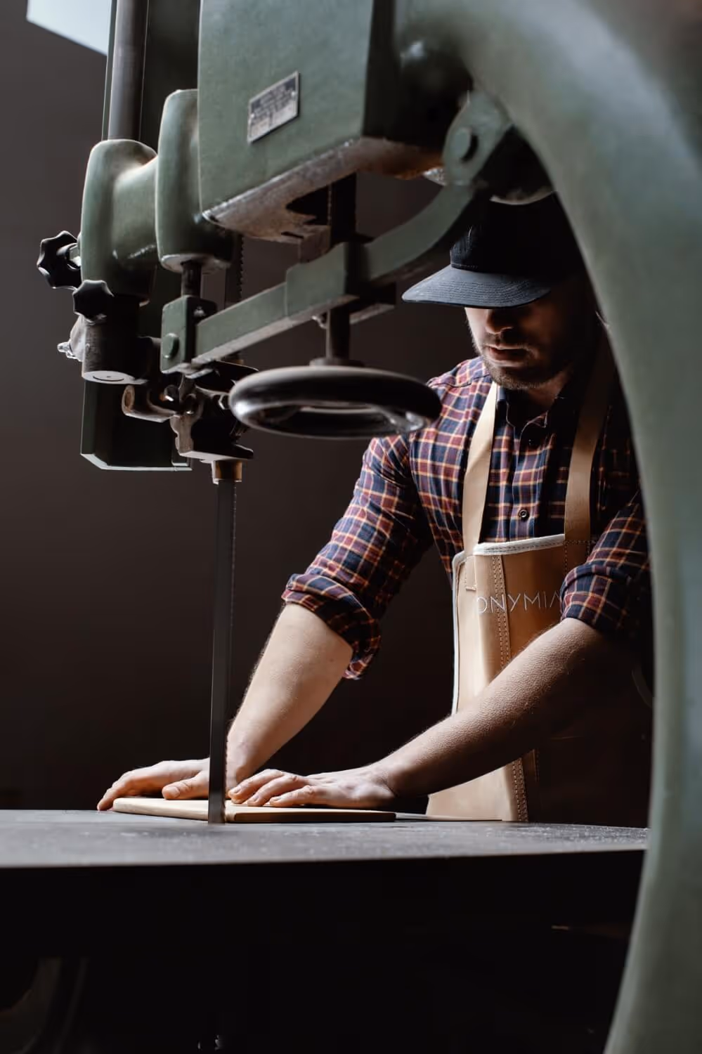 Solid wood block being shaped into furniture by Anonymia craftsmen, close-up view