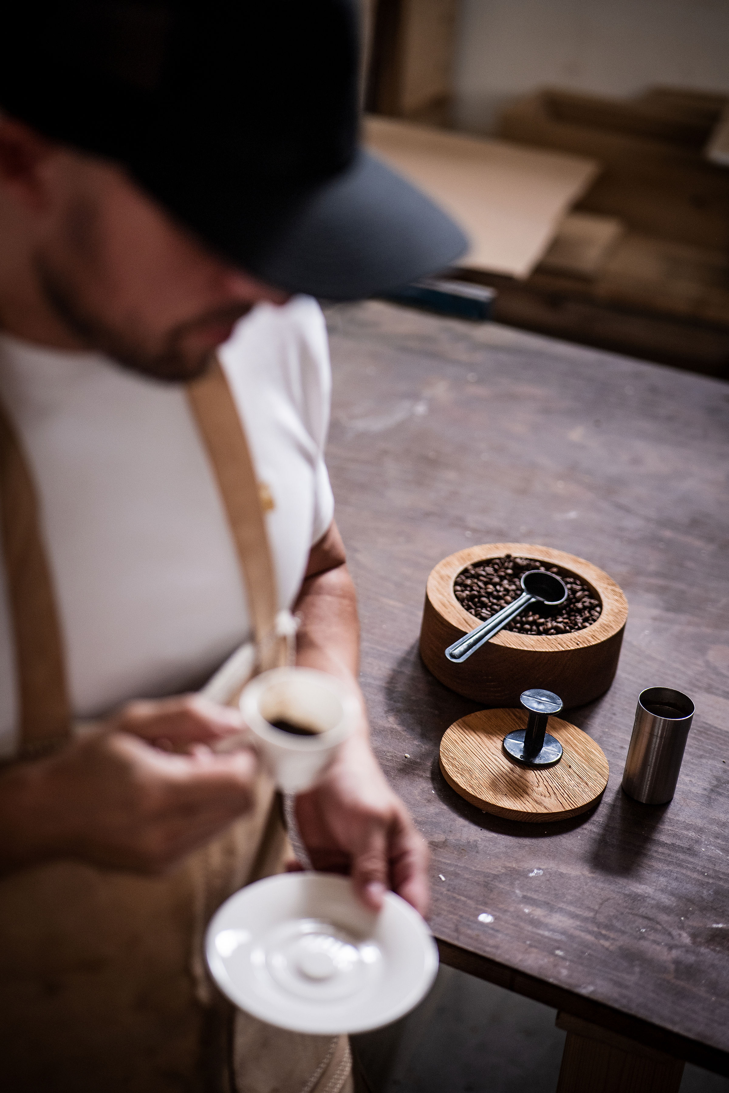 Craftsman carving a solid piece of wood in Anonymia workshop