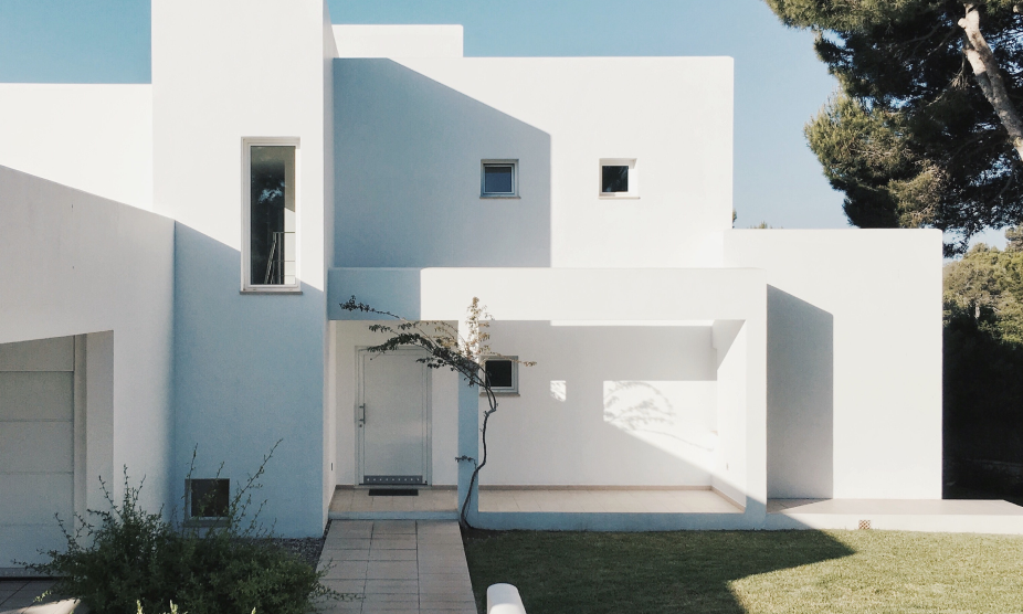 a white house with a green lawn