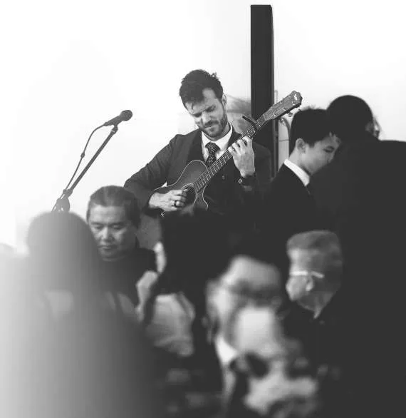 Dylan Galvin playing guitar and singing