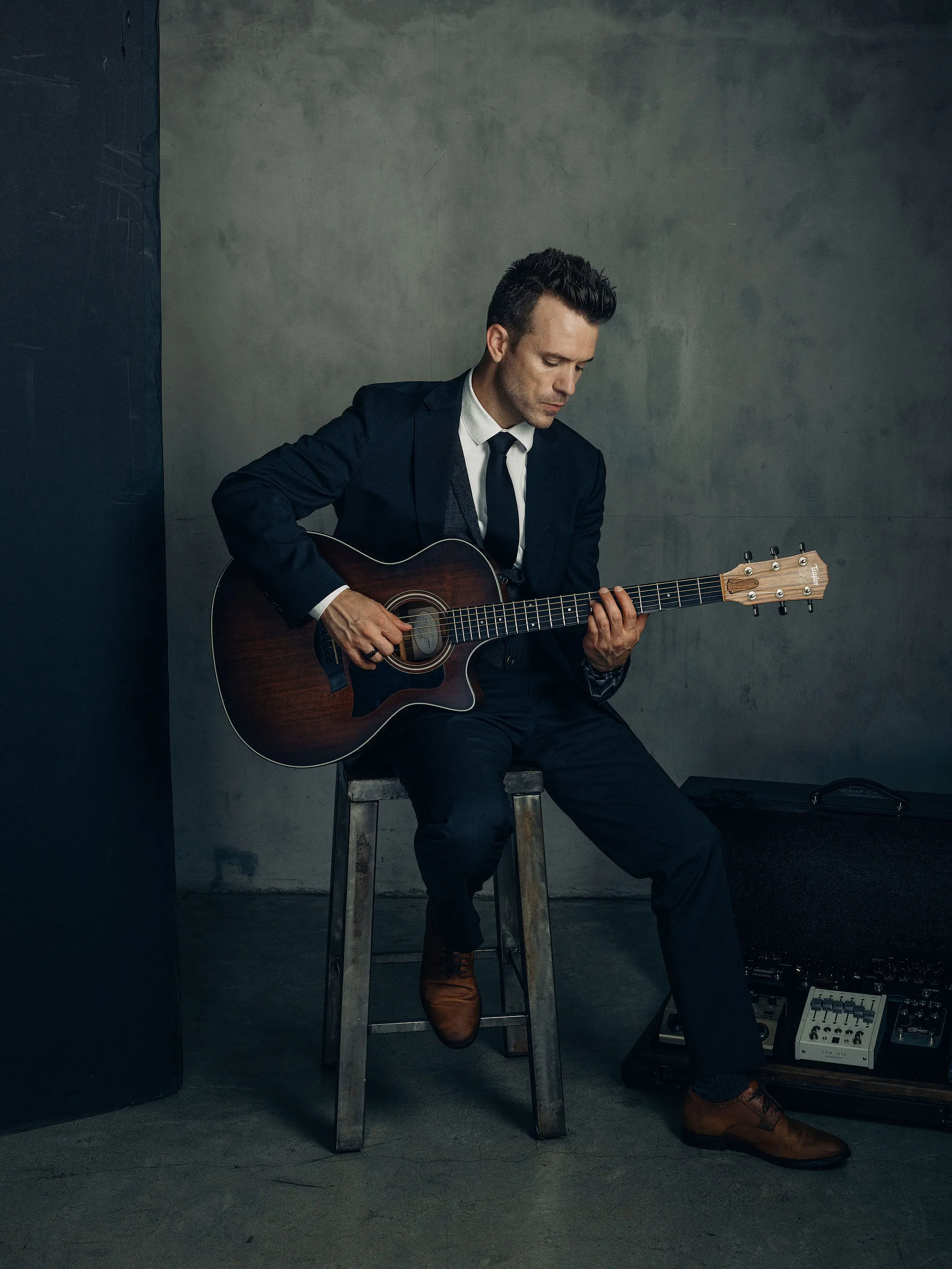 Dylan Galvin playing his acoustic guitar.