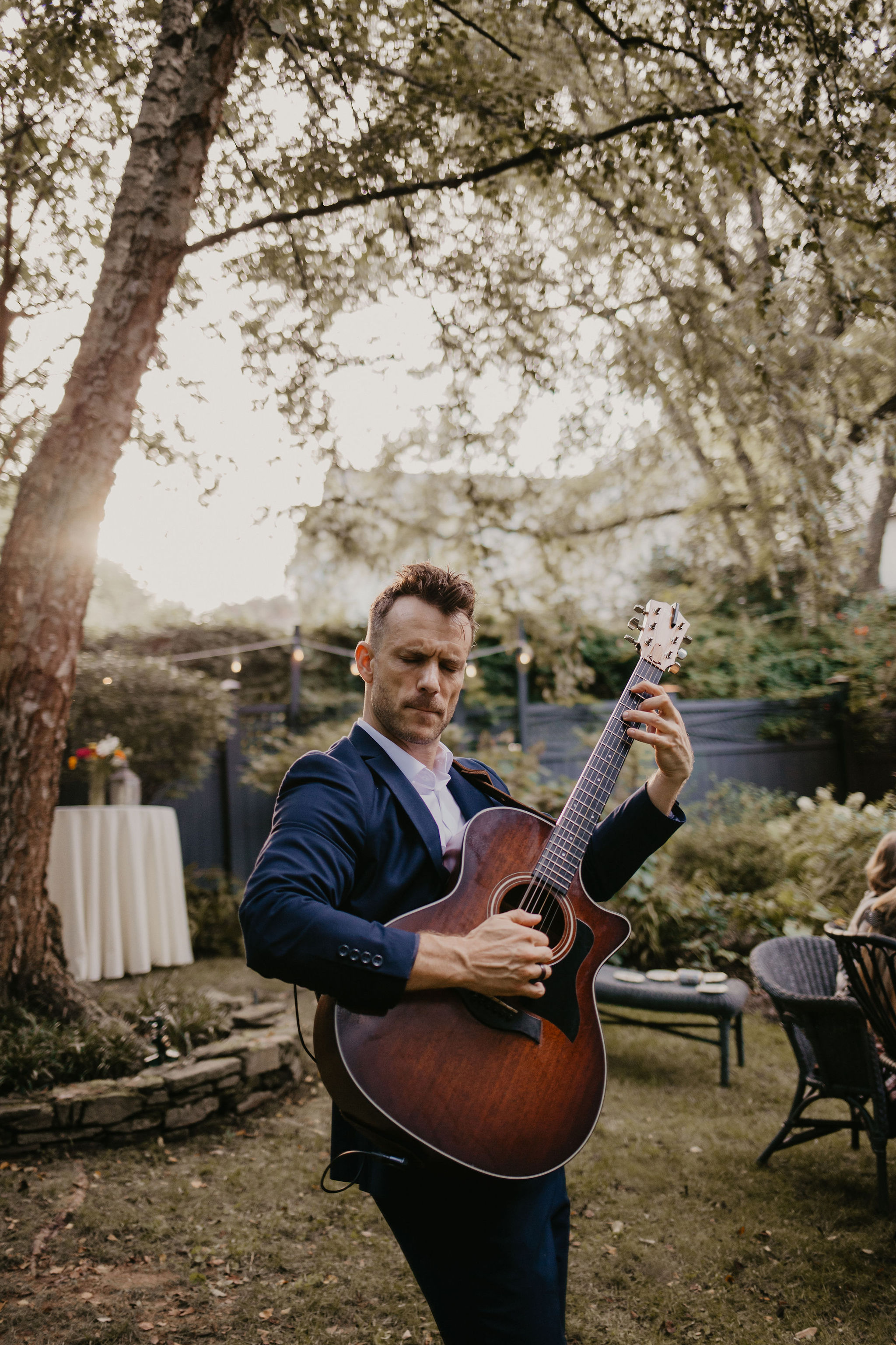 Dylan Galvin performing live acoustic guitar at a wedding cocktail hour