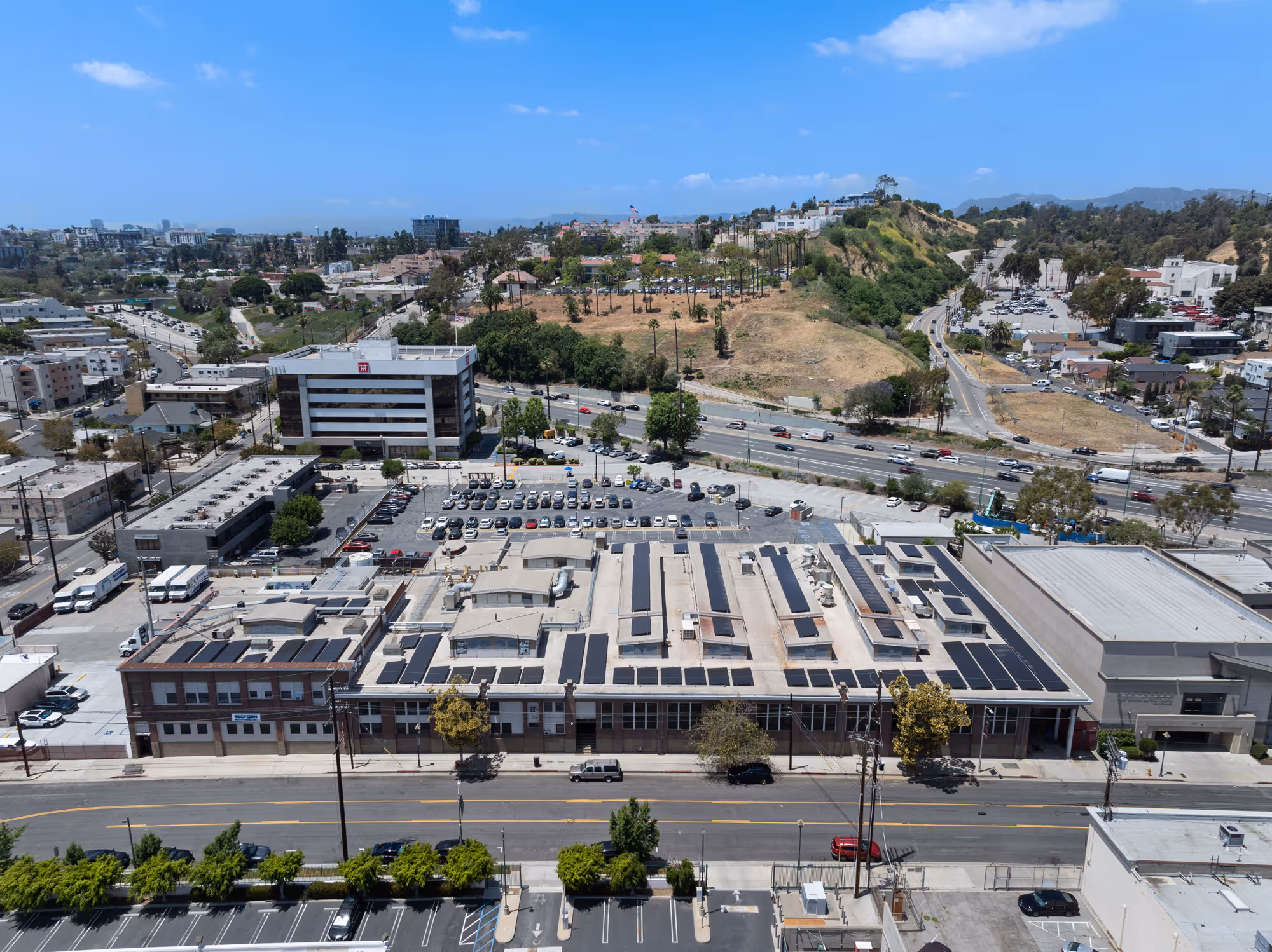 Aerial photo of a 232.1 kW commercial solar system installed on a flat rooftop in California.