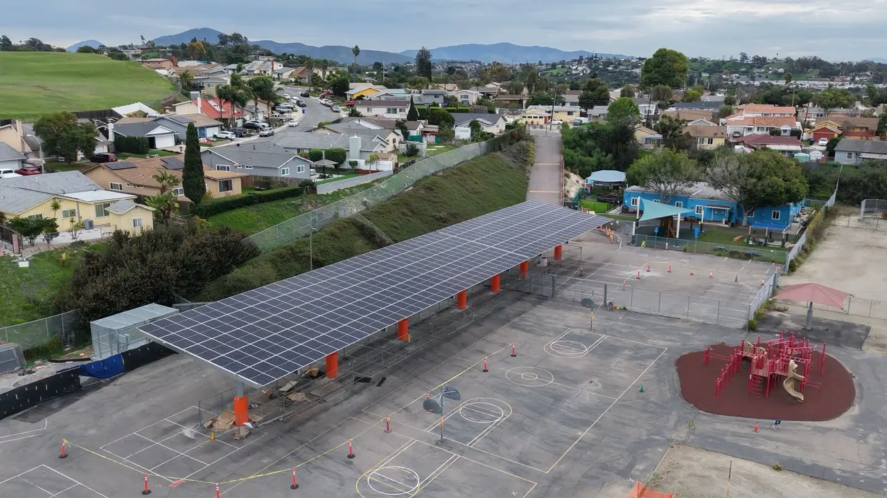 Aerial view of a school playground with a large solar carport canopy