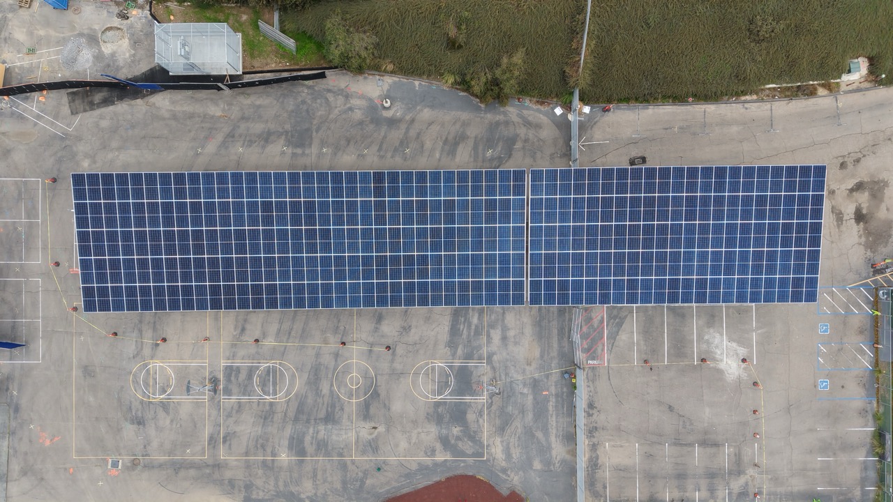 Aerial shot of a carport on an elementary schoolDrone aerial image of solar carport installation at Johnson Elementary School, a commercial solar project for SDUSD.