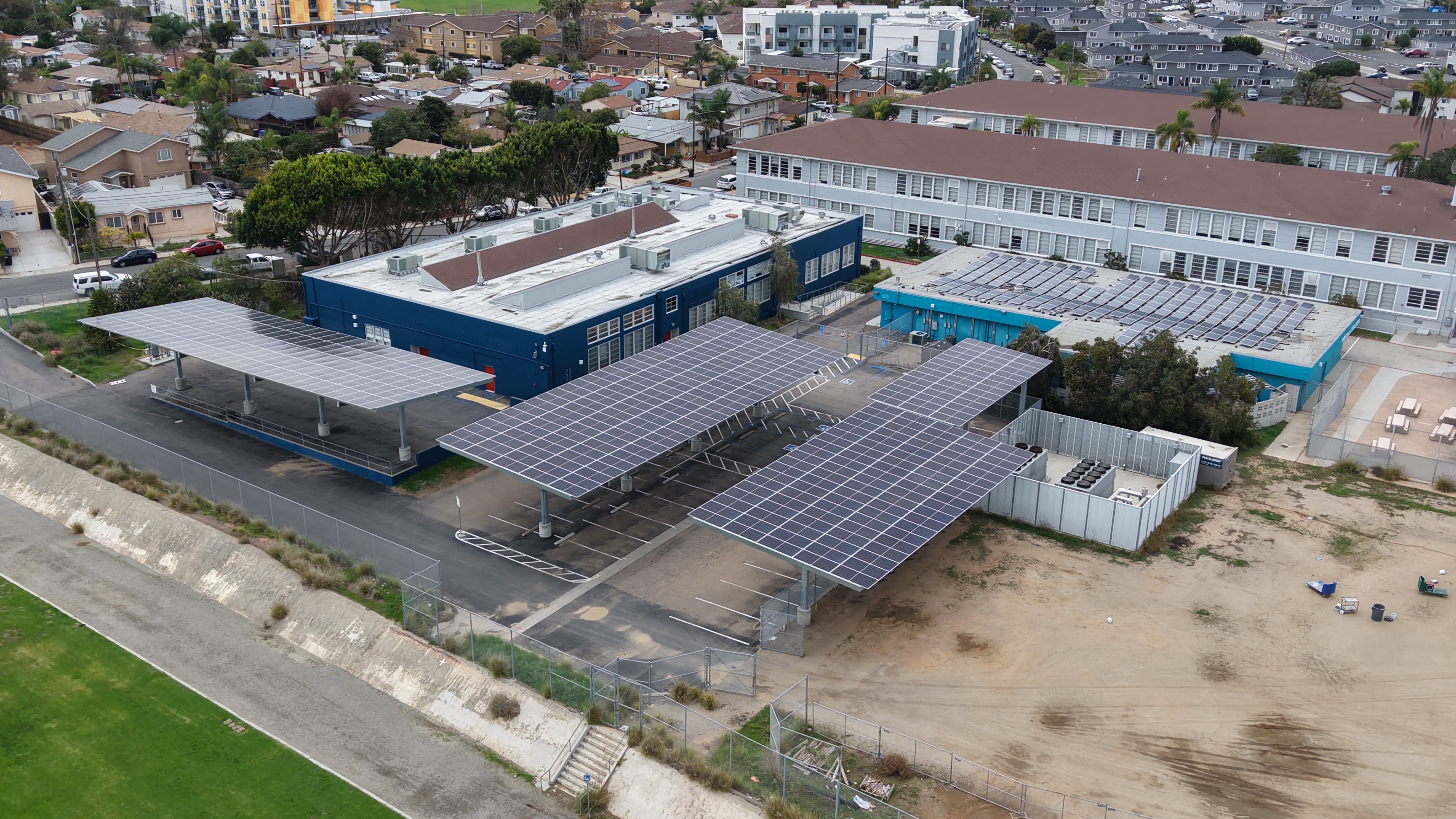 Aerial view of a roof and carport solar installation at a middle school in SDUSD