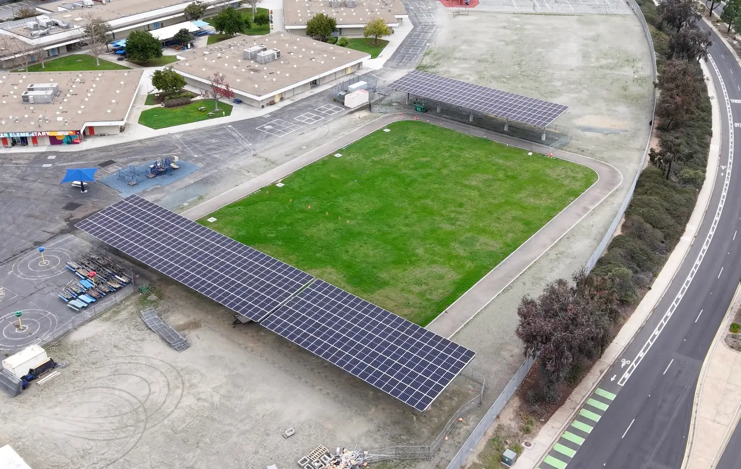 DSA solar project at Miller Elementary School featuring large solar carport structures installed for campus energy production.