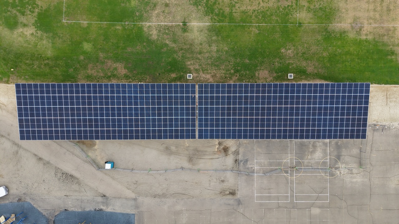 Aerial drone image of commercial solar installation at Gage Elementary School featuring solar carport structures for SDUSD school energy generation