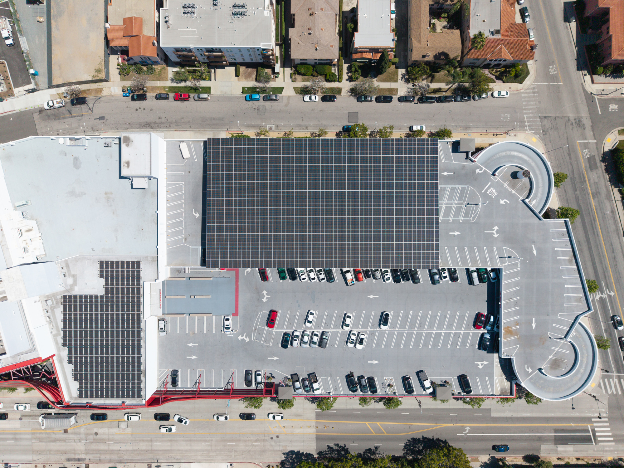 Top-down aerial of Petersen Solar Installation with Commercial Solar carport and rooftop solar PV panels at the site.
