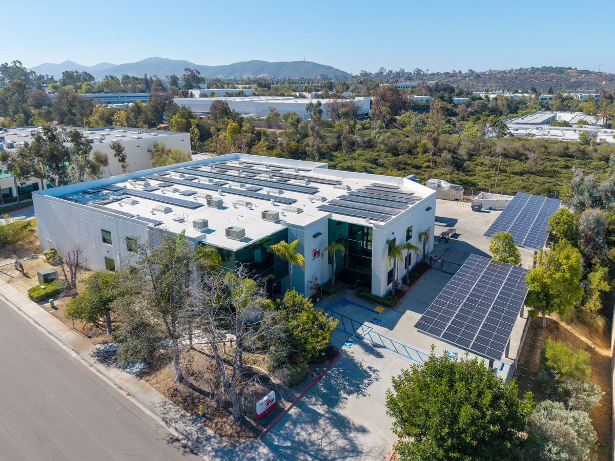 Aerial view of a carport and rooftop commercial PV system in San Diego