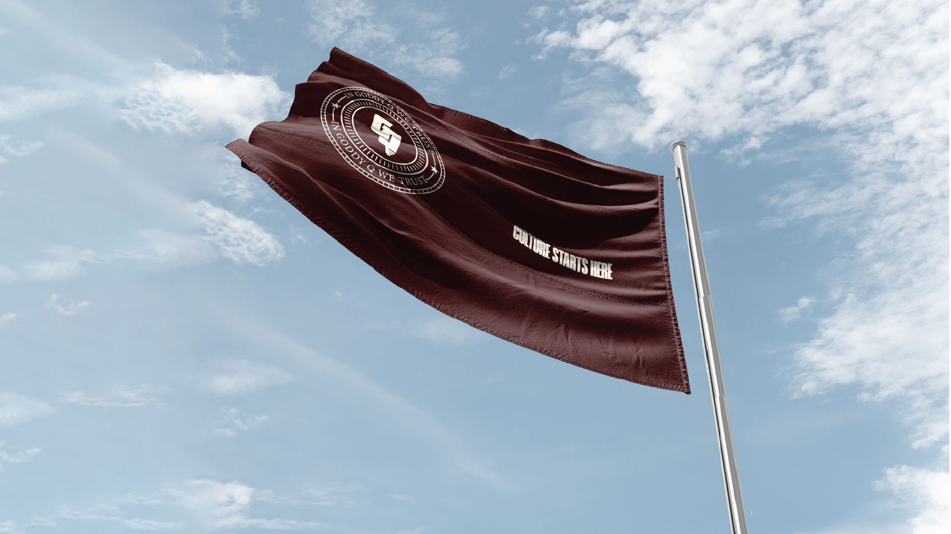 Dark maroon flag waving against a partly cloudy sky with a circular emblem and the text 'CULTURE STARTS HERE'.