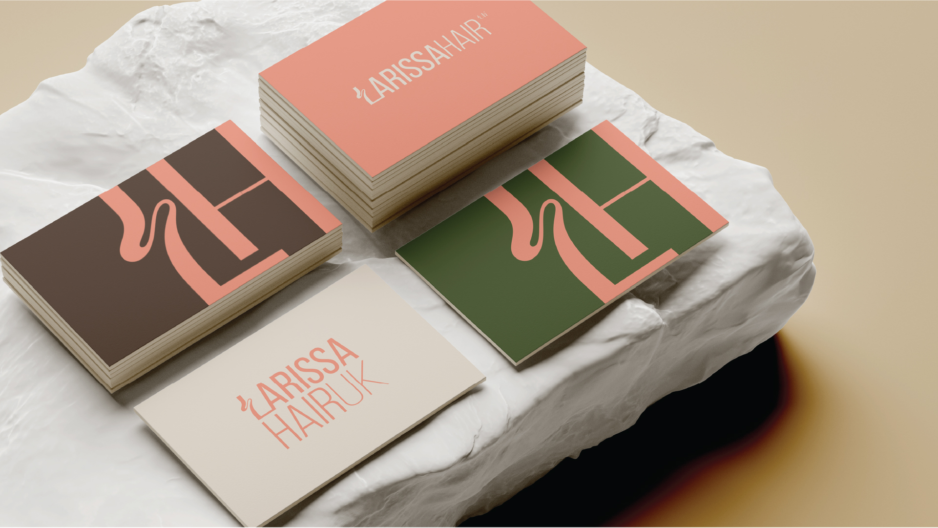 Four stacks of artistic business cards for Larissa Hair UK in coral, brown, green, and cream colors on a textured white stone surface.