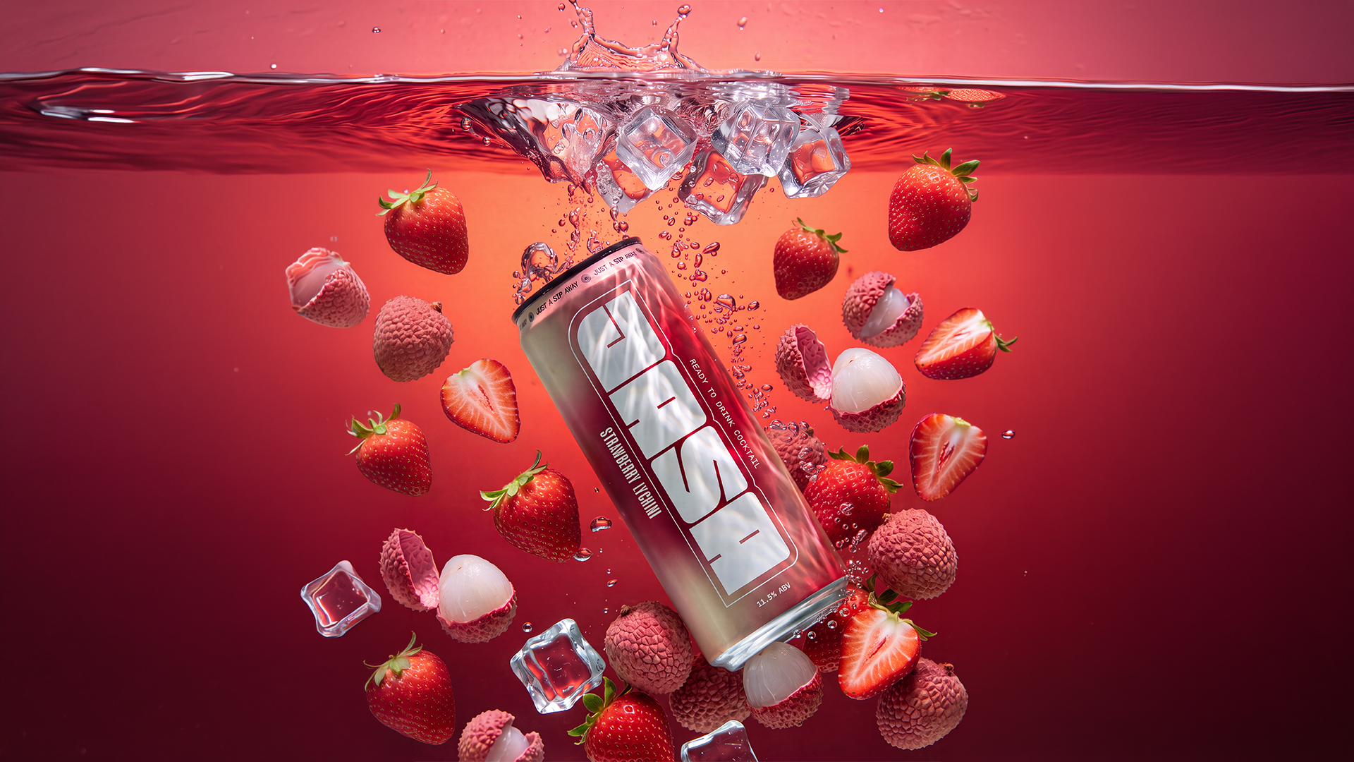 A can of JASA Strawberry Lychee ready-to-drink cocktail submerged in red liquid with ice cubes, whole and halved strawberries, and whole and peeled lychees floating around.