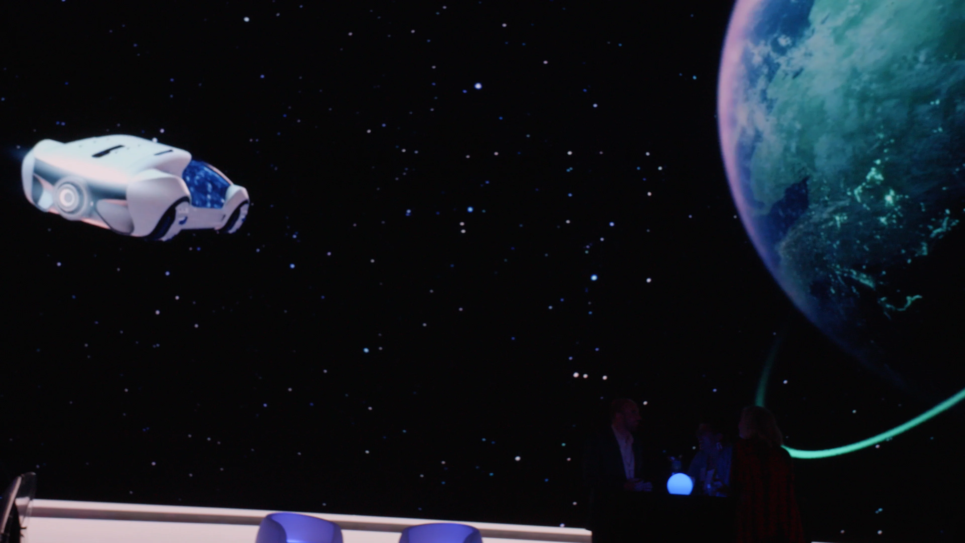 Imprint's immersive sci-fi screen transports guests past a glowing planet at the Burns McDonnell activation