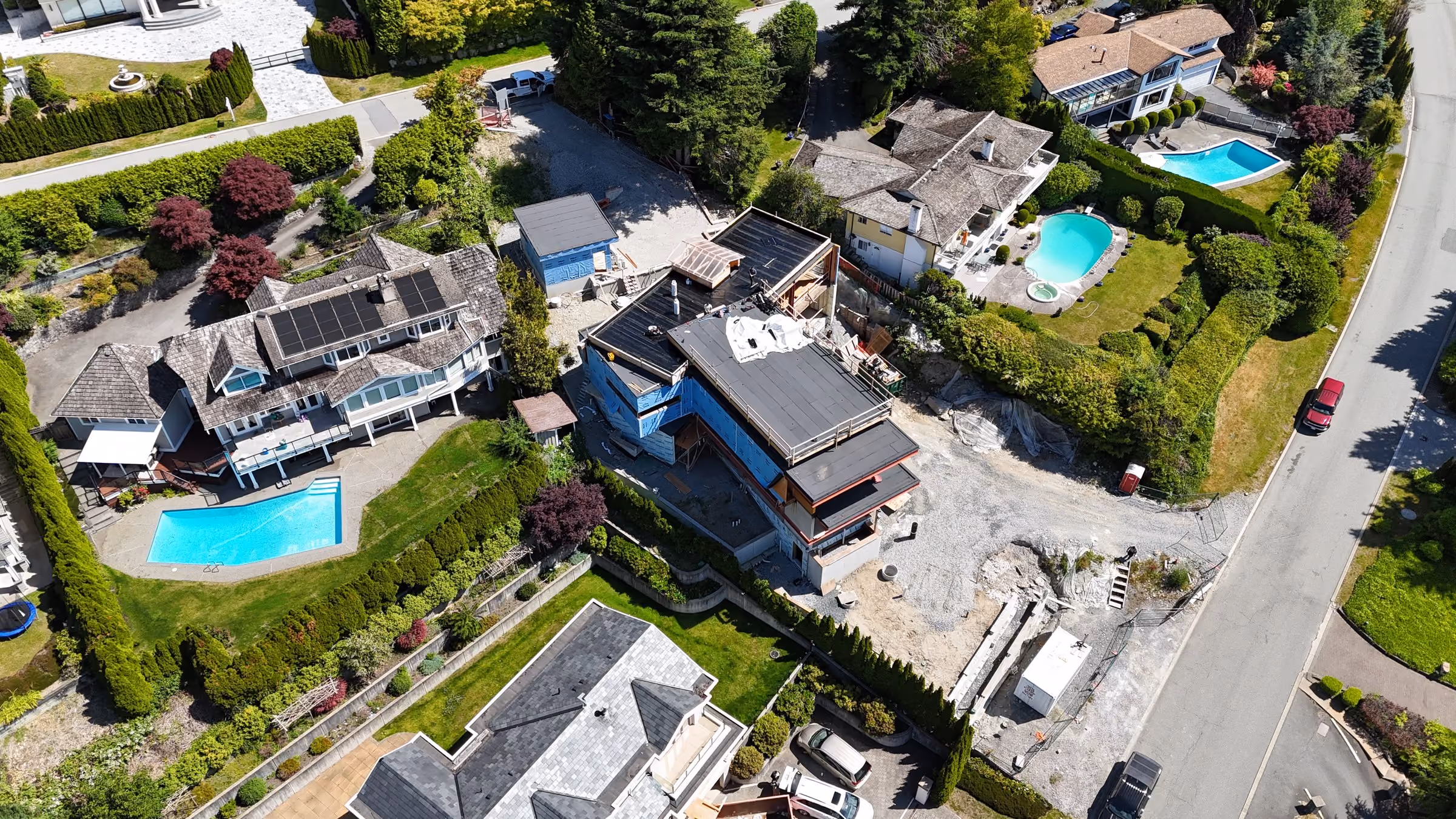 Aerial drone survey of a new-construction home with a torch-on flat roof in the Lower Mainland