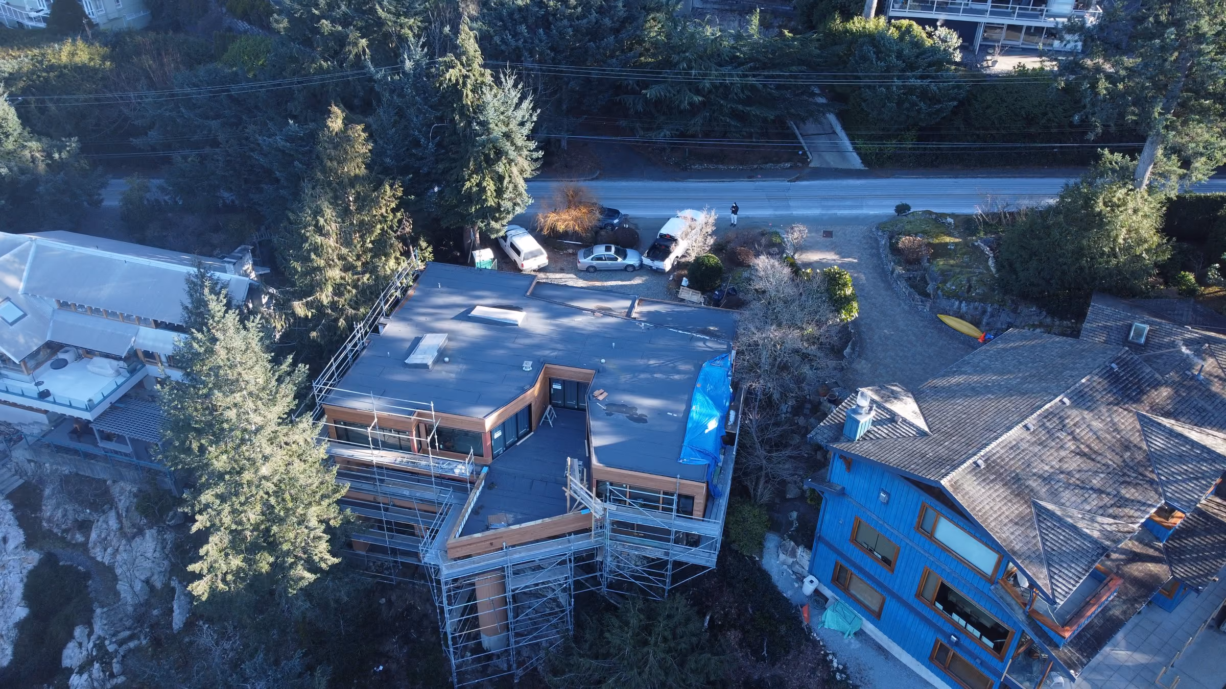 Drone view of a torch-on membrane roof on a modern waterfront home under construction in Metro Vancouver