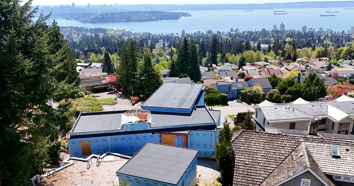 Aerial view of a torch-on flat roof in West Vancouver, with English Bay and the Vancouver skyline behind it