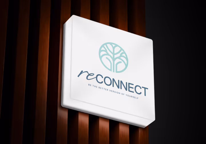 Illuminated sign with a tree logo and the text 'reCONNECT Be the better version of yourself' mounted on a wooden slat wall.