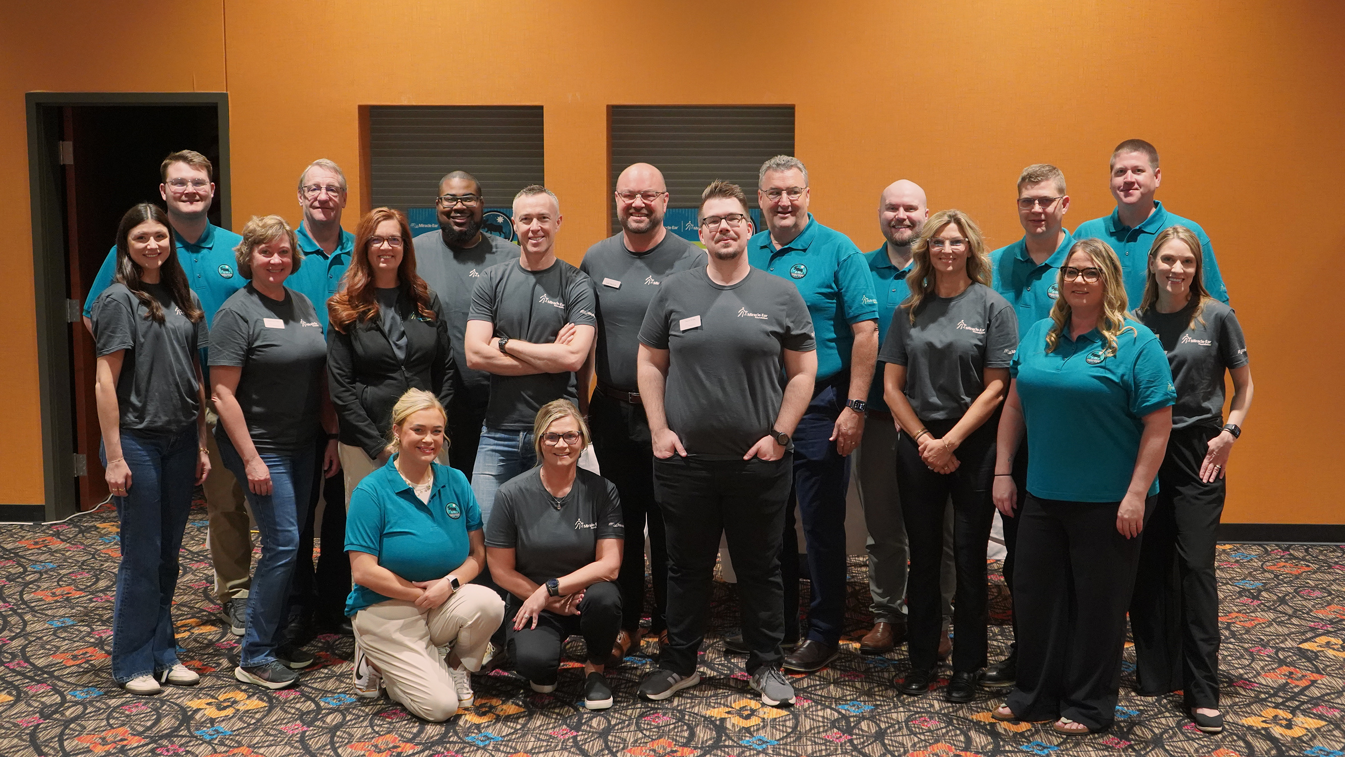 The Miracle-Ear Foundation mission team photographed together in branded polo shirts
