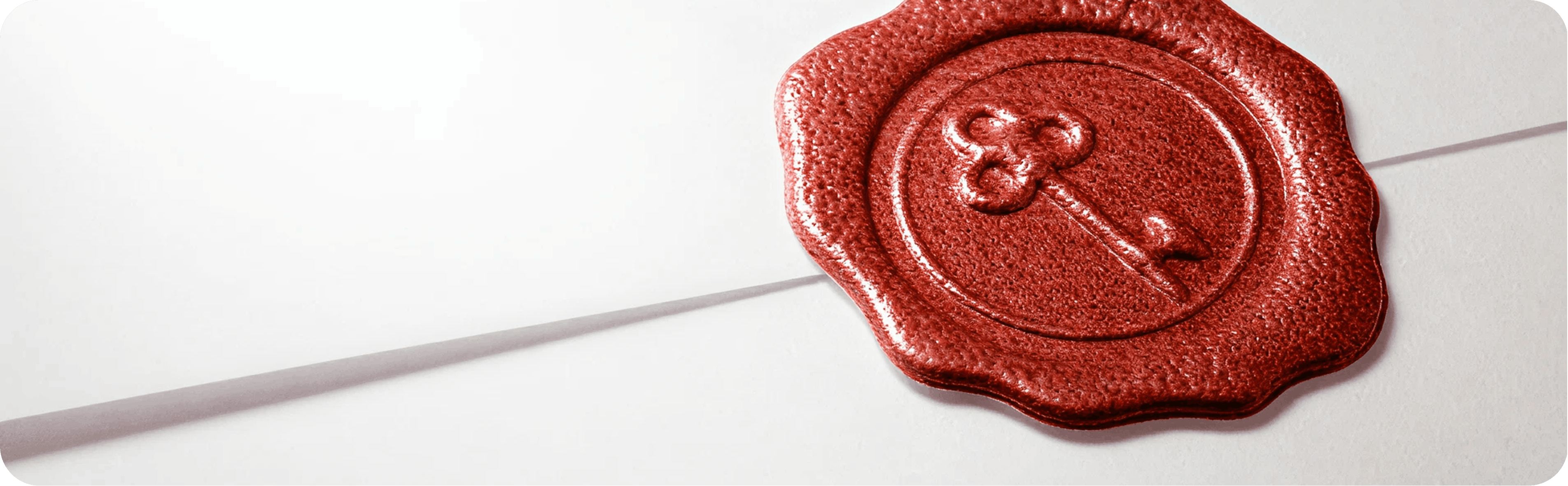 Red wax seal with a key emblem on a sealed envelope