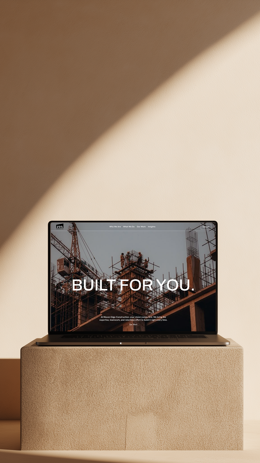 Laptop on wooden table displays logistics website with truck image and commitment message.