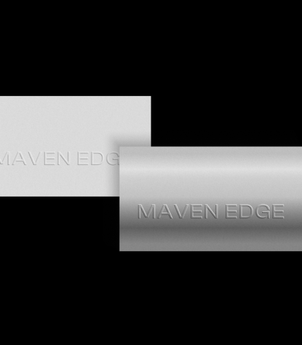 Two embossed metal plates overlapping, each engraved with the text 'MAVEN EDGE'.