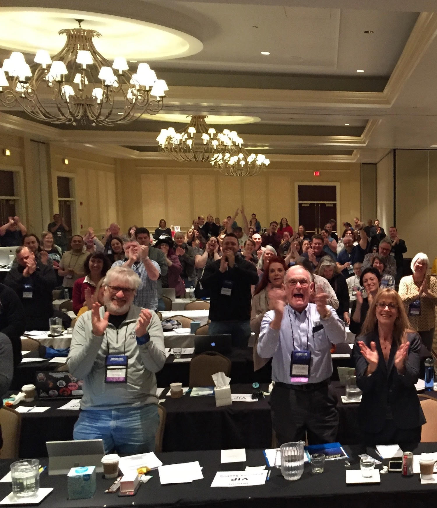 Attendees standing up clapping