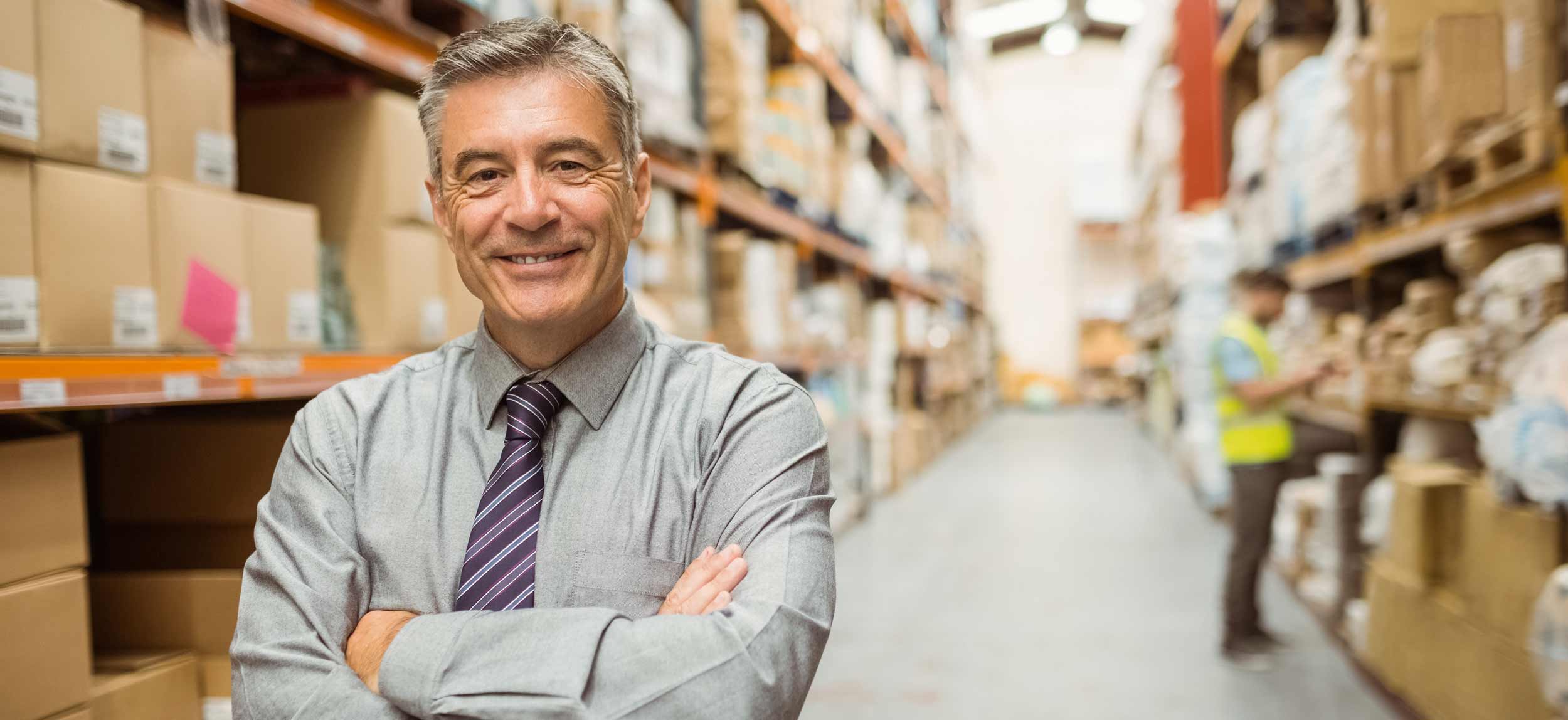 A smiling warehouse manager.