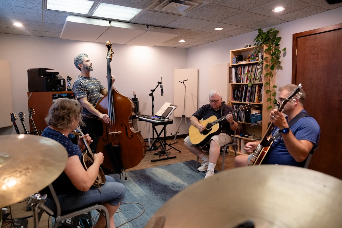 “Adult student playing mandolin during private lesson at Cincinnati Music Academy.