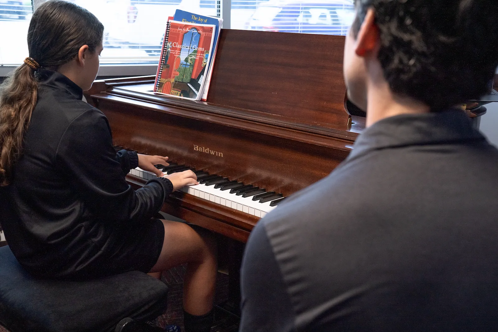 Teen piano student practicing during private lesson at Cincinnati Music Academy.