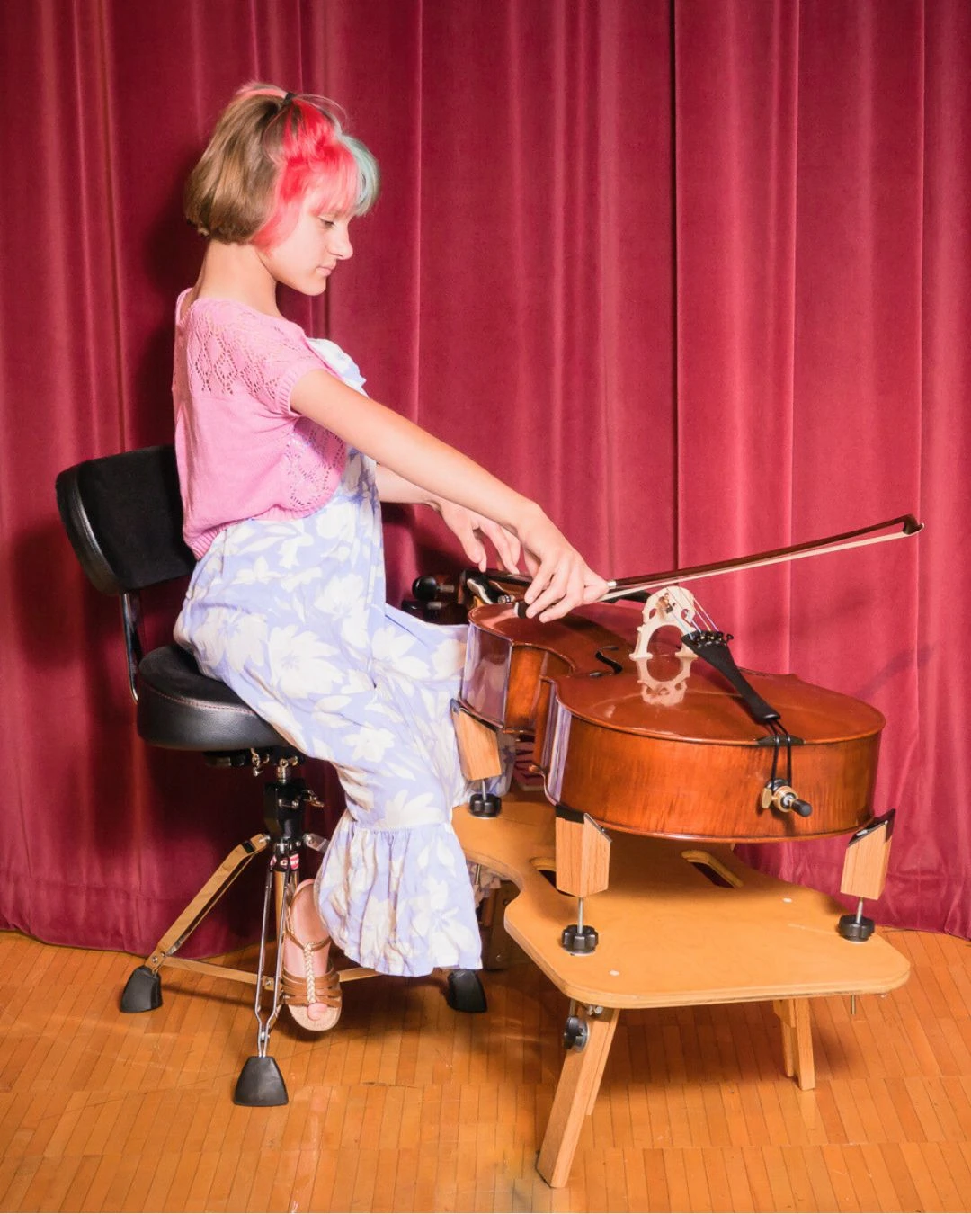 Young cello student performing at a recital at Cincinnati Music Academy