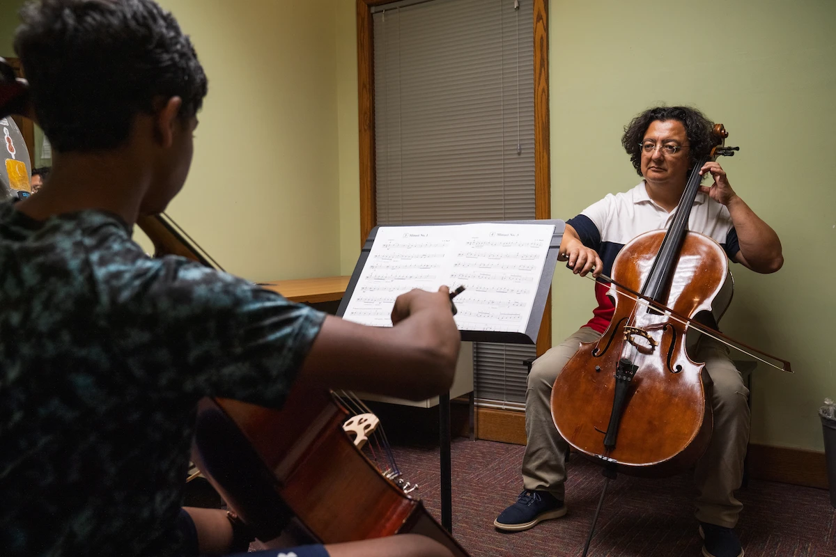 Cello instructor teaching a student during a private strings lesson at Cincinnati Music Academy.
