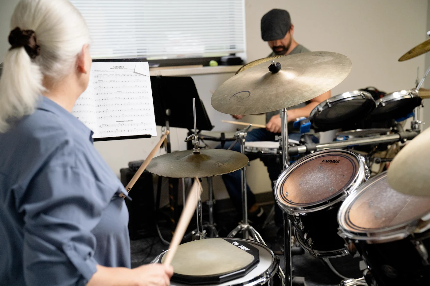 Drums instructor teaching an adult student during a private percussion lesson at Cincinnati Music Academy.