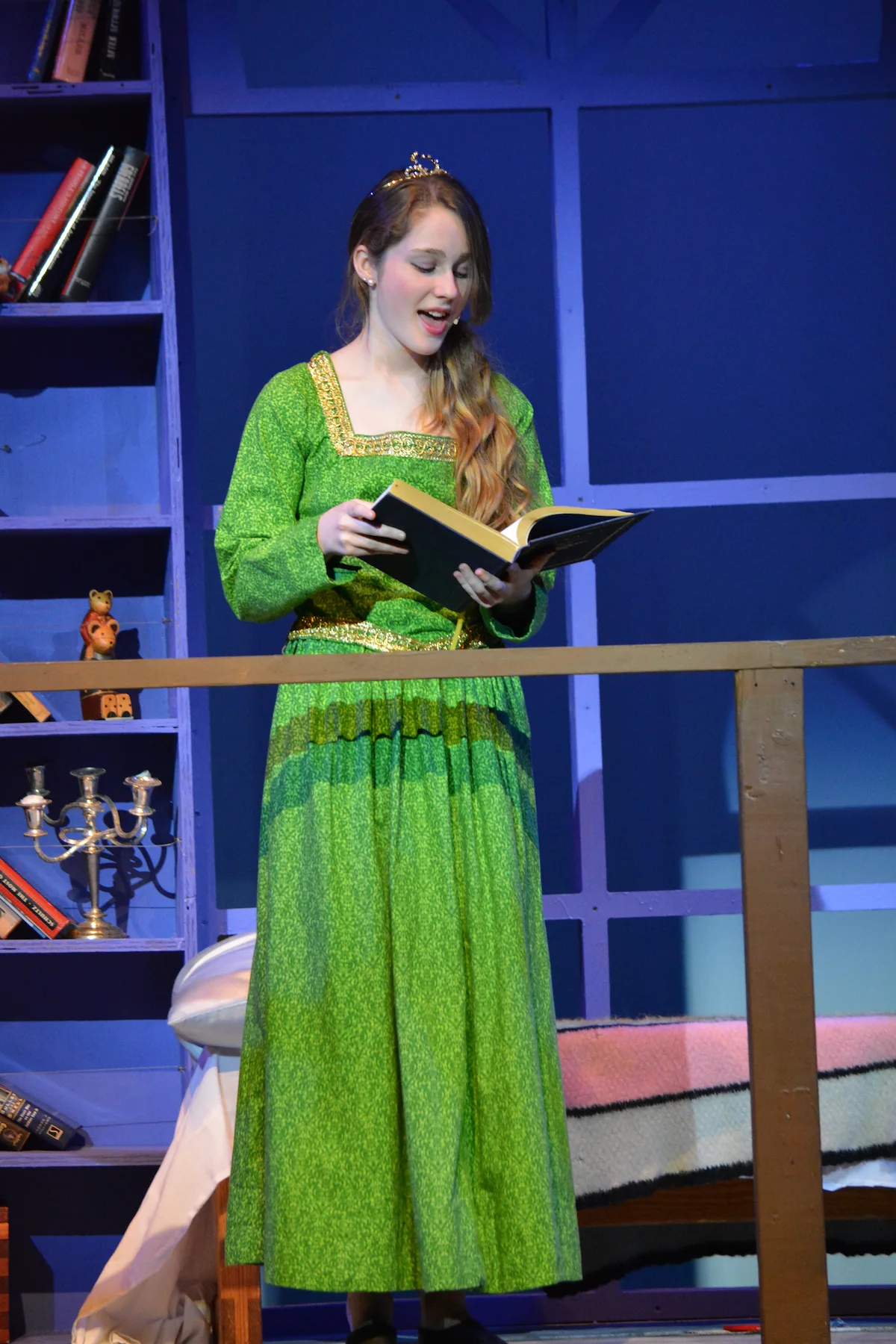 Teen acting student rehearsing a script on stage during private acting coaching at Cincinnati Music Academy.