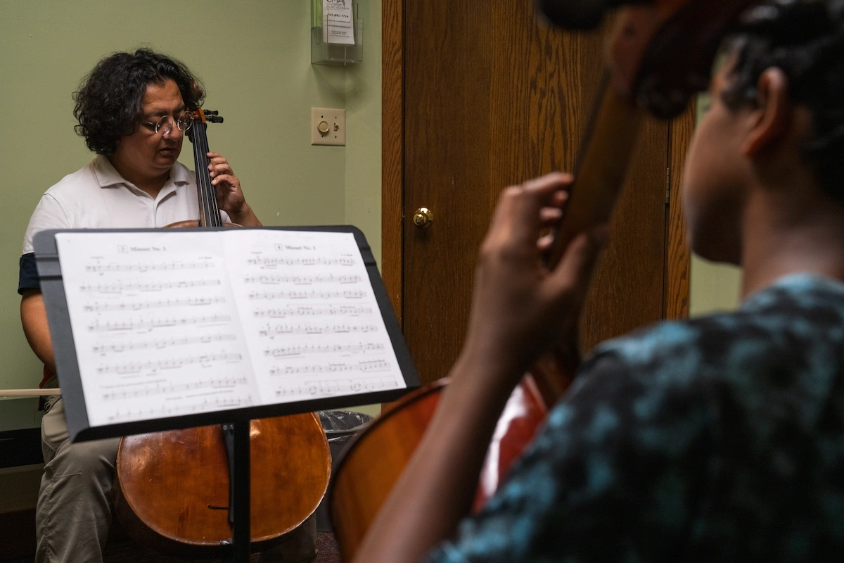 Adult cello students rehearsing ensemble music at Cincinnati Music Academy in Kenwood.