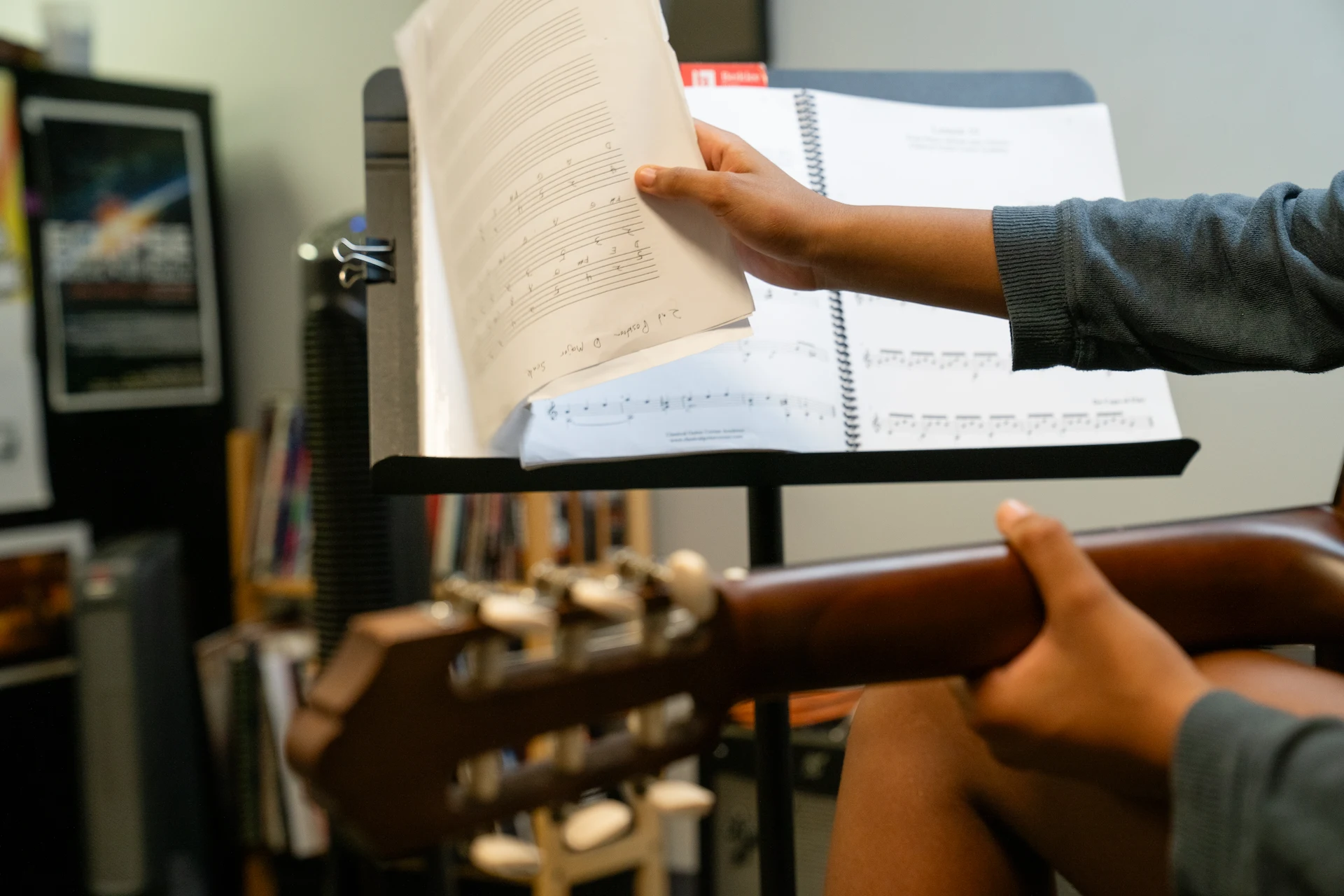 Student reviewing sheet music during a guitar lesson at Cincinnati Music Academy.