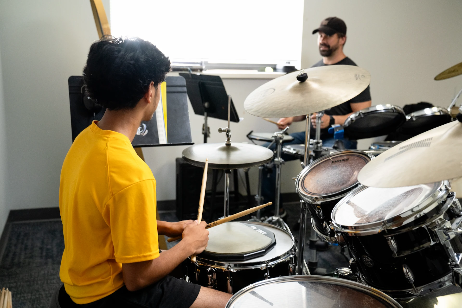 Student practicing drums with an instructor during a private lesson at Cincinnati Music Academy.