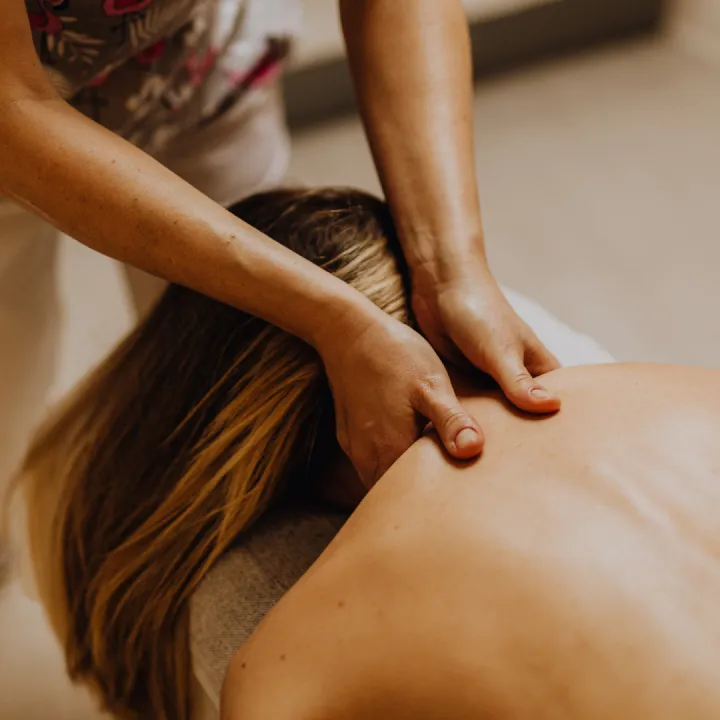 therapist performing gentle neck and shoulder bodywork