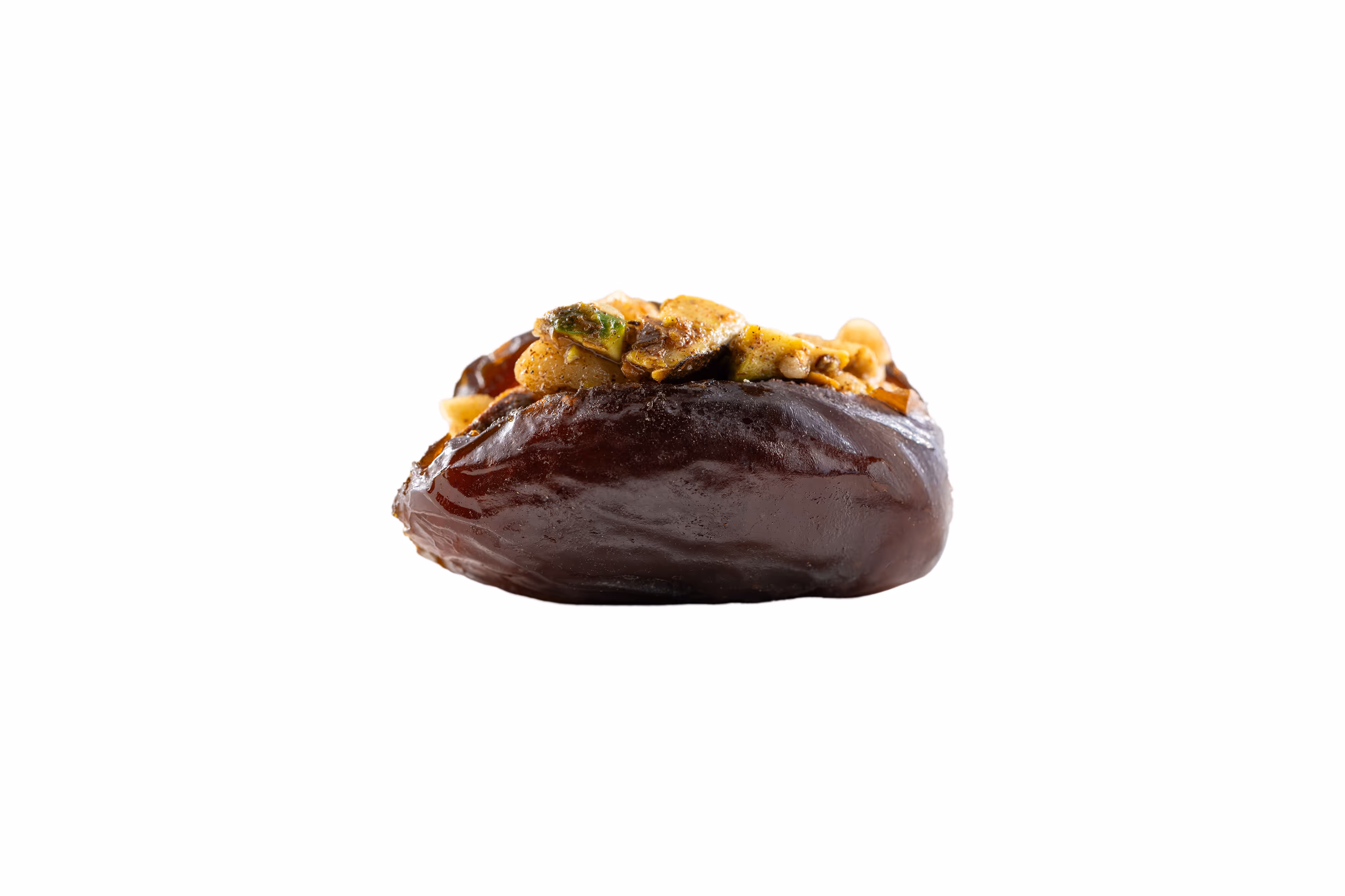 Chocolate confection topped with crushed pistachio nuts on a white background.