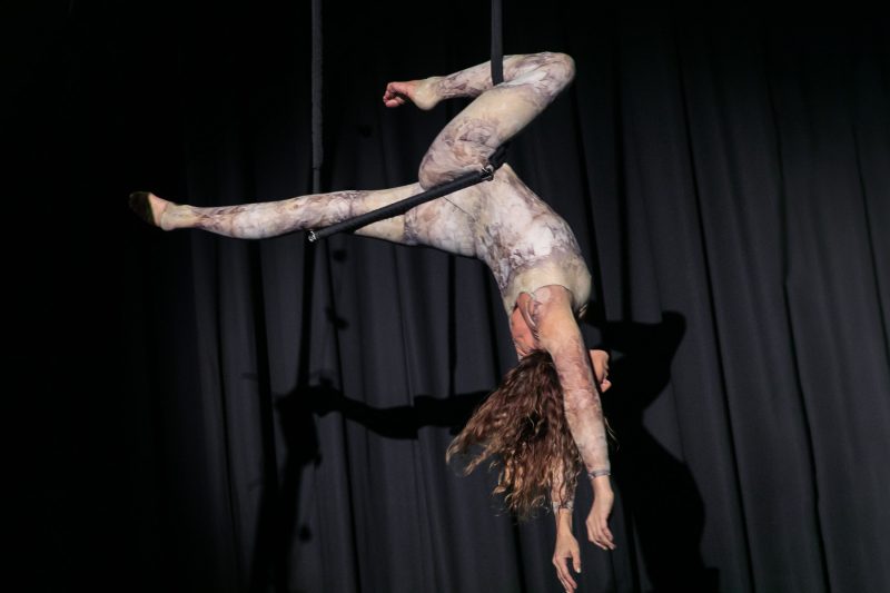 A woman taking part in trapeze circus skills.