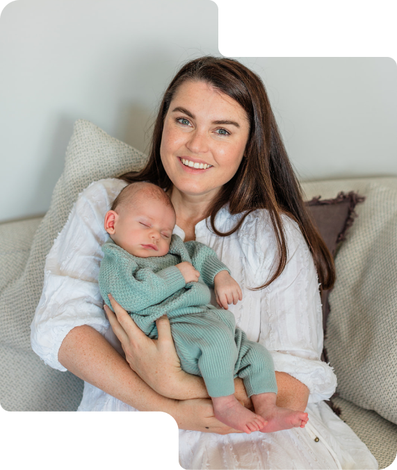 Image of Meghan, founder of mothers club holding her newborn baby