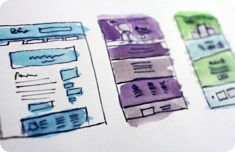 3 low-fidelity wireframes of a mobile app displayed next to each other. They all have been colored with low contrasting background colors.