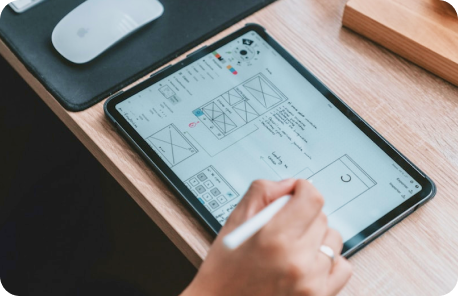 Designer drawing wireframes for a mobile application on an iPad device