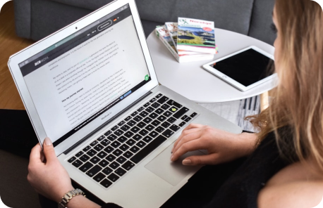 Person reading text content on website using a laptop device.