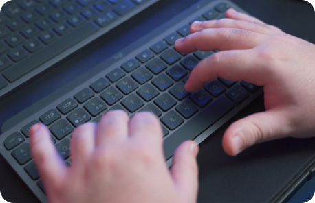 Top view of tester using keyboard for manual accessibility audit.